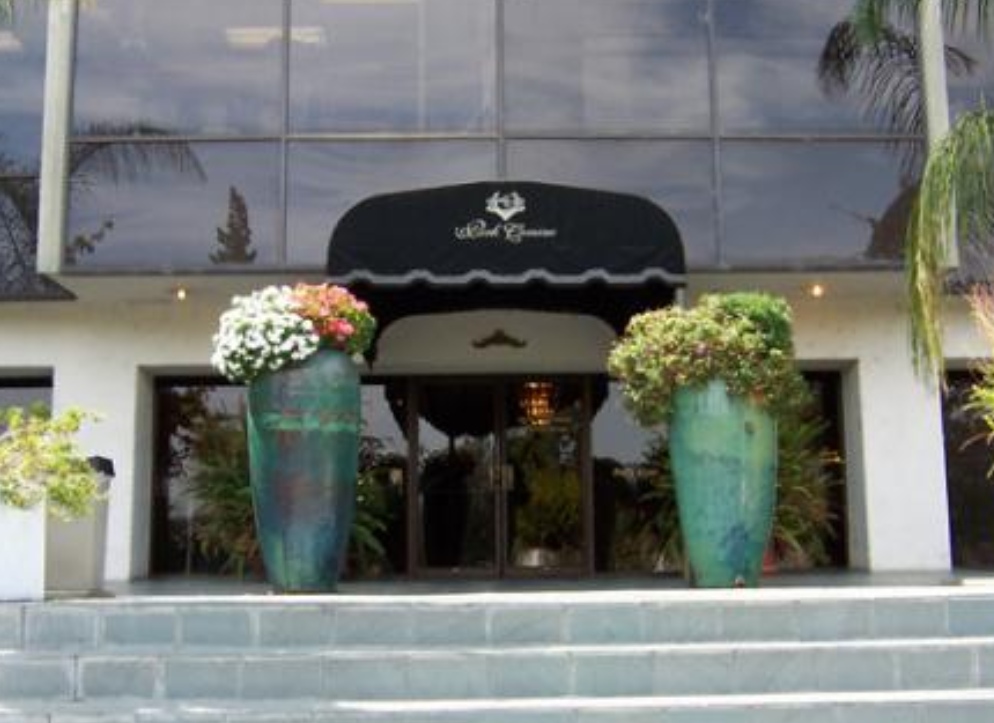 A large entrance way with flowers in vases.